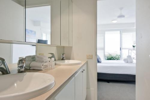 a white bathroom with two sinks and a bed at Crest Premium View Apartment 19 in Noosa Heads