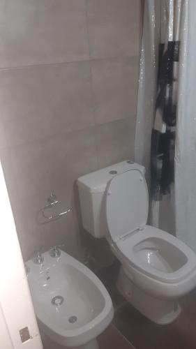 ein weißes Bad mit einem WC und einem Waschbecken in der Unterkunft 9y45 in La Plata