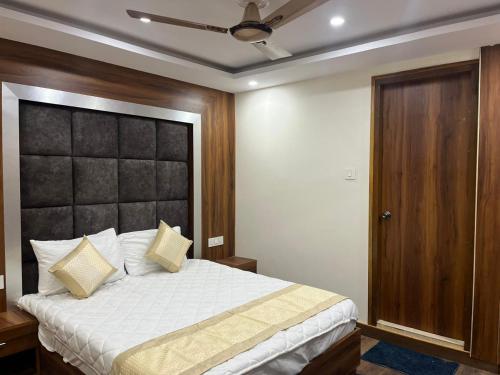 1 dormitorio con 1 cama grande y cabecero negro en HOTEL SHAILJA & AD CONTINENTAL RESTAURANT, en Jyotirmath