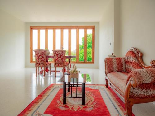 a living room with a couch and a table and chairs at Nichahome Luxury Villa in Hua Hin
