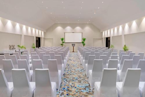an empty banquet hall with white chairs and a whiteboard at Sheraton Resort & Spa, Tokoriki Island, Fiji in Tokoriki