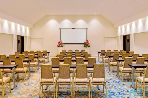 a conference room with tables and chairs and a whiteboard at Sheraton Resort & Spa, Tokoriki Island, Fiji in Tokoriki