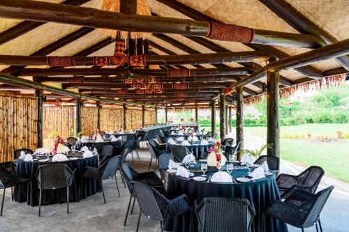 a group of tables and chairs in a pavilion at Sheraton Resort & Spa, Tokoriki Island, Fiji in Tokoriki