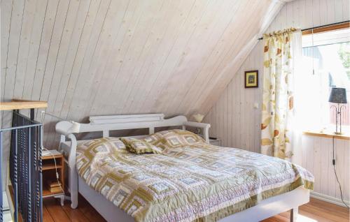 a bedroom with a white bed in a attic at Beautiful Home In Munka-ljungby With Wifi in Munka-Ljungby