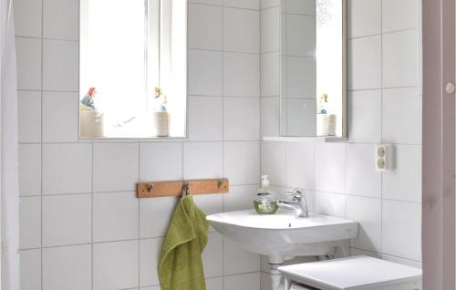 a white bathroom with a sink and a toilet at Beautiful Home In Munka-ljungby With Wifi in Munka-Ljungby