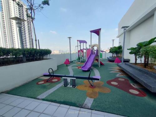 a playground with a slide and a play area at Da Best Guesthouse One Maxim Sentul Nice Cozy Condo 3 Rooms Aircond in Sentul KL in Kuala Lumpur