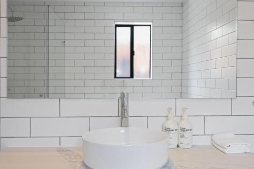 a white bathroom with a sink and a mirror at Clare Country Club in Clare