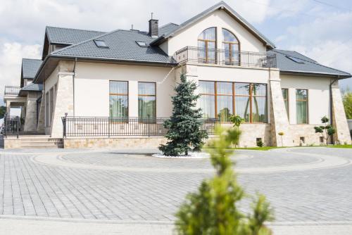 a house with a driveway in front of it at Hotel Aleksandria in Siedlce