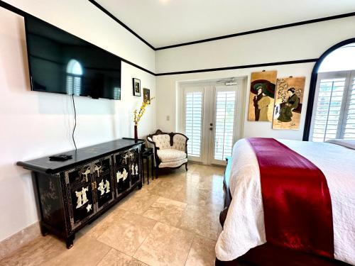 a bedroom with a bed and a dresser at Bliss By The Sea in Saint Augustine