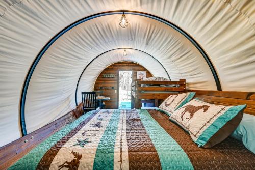 a bedroom with a bed in a tent at Ultimate Covered Wagon Pioneers Paradise in Brownsville