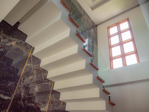 a staircase in a house with a window at Nichahome Luxury Villa in Hua Hin