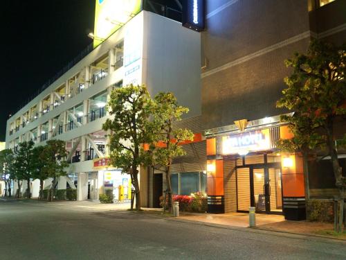 an empty street in front of a building at night at APA Hotel Saitama Yatsuka Ekimae in Soka