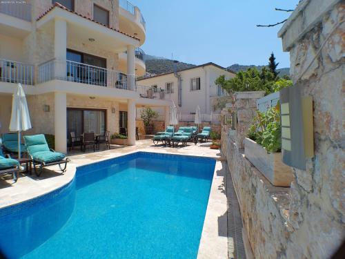 a swimming pool in front of a house at Truffle Residences in Kalkan