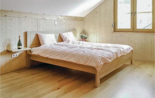 a bedroom with a large bed with a wooden floor at Cozy Home In Altaussee With Sauna in Altaussee
