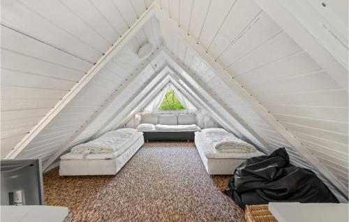 a attic room with two couches and a window at 3 Bedroom Gorgeous Home In Toftlund in Vestergård