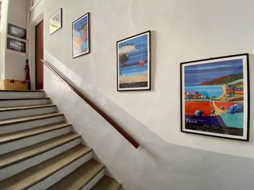 a set of stairs with posters on the wall at Da Amélie - Casa Ludovica nel cuore della Gran Madre a Torino in Turin
