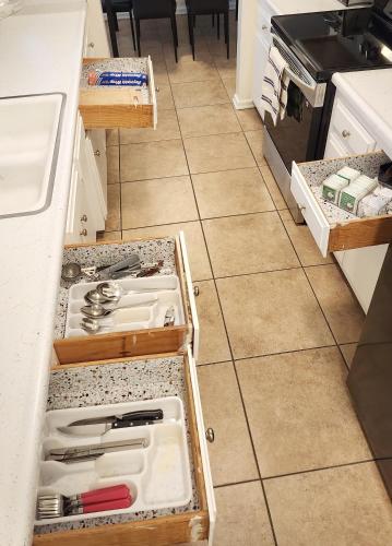 a kitchen with an open drawer with knives and utensils at Centrally Located, 4x Queen, 300 MBPS Internet with Backyard! in Hemet