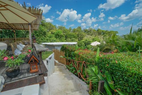 a garden with plants and a bird house on a patio at Milo's Home in Jimbaran