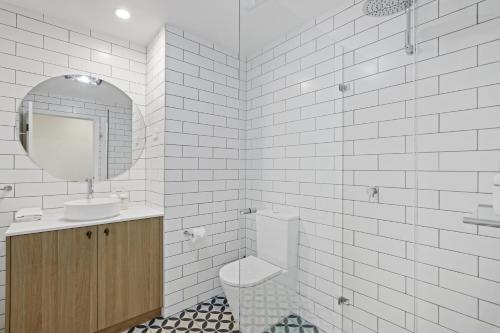 a bathroom with a toilet and a sink and a mirror at Clare Country Club in Clare