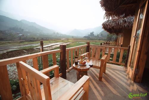 a balcony of a house with a table and chairs at Sapa Eco Homestay in Sa Pa