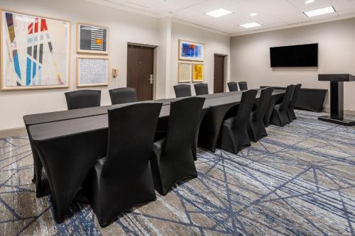 a conference room with a long table and chairs at Holiday Inn Express and Suites Tampa I-75 at Bruce B. Downs by IHG in Tampa