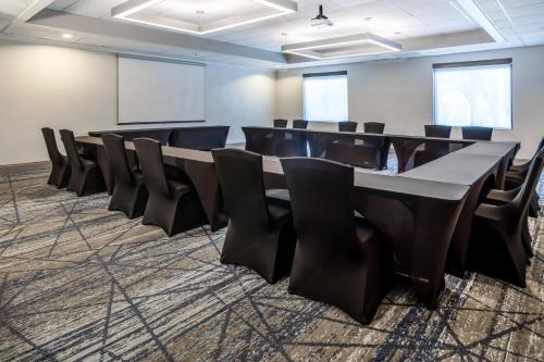 a conference room with a long table and chairs at Holiday Inn Express and Suites Tampa I-75 at Bruce B. Downs by IHG in Tampa