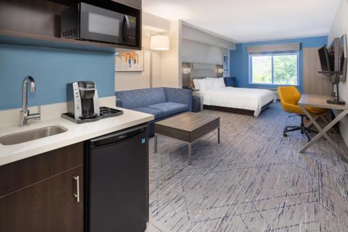 a kitchen and living room in a hotel room at Holiday Inn Express and Suites Tampa I-75 at Bruce B. Downs by IHG in Tampa