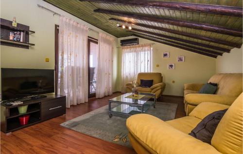 a living room with a couch and a tv at Five-Bedroom Holiday Home In Zadar in Zadar