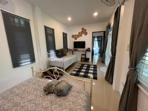 a bedroom with a bed and a living room at ComeHome Lamphun in Lamphun