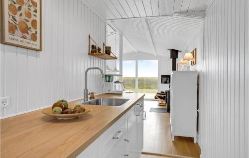 a kitchen with a sink and a bowl of fruit on the counter at Cozy Home In Haderslev With Wifi in Haderslev