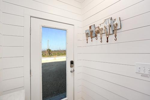 a door to a house with a view of a road at Pelican Crossing by Pristine Properties Vacation Rentals in Cape San Blas