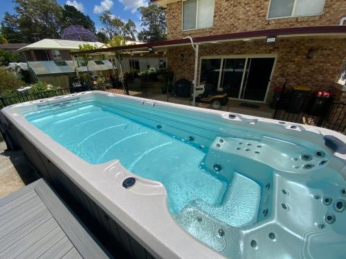 a large swimming pool in front of a house at Farm Stay at Camellia Cottage pet friendly in Picton