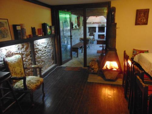 a living room with a wood stove in a room at Къща за гости Старата череша село Раждавица in Rzhdavitsa