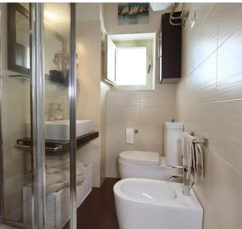 a bathroom with a toilet and a sink at Casa Christine in Taormina