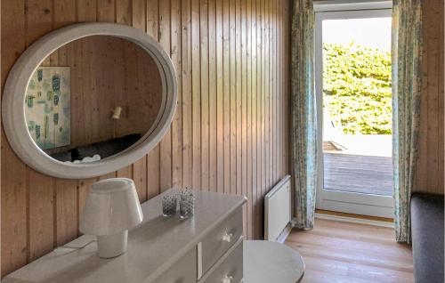 a bathroom with a mirror and a white dresser at Nice Home In Faaborg With 3 Bedrooms And Wifi in Faaborg