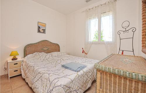 a bedroom with a bed and a window with a man figure on the wall at Awesome Home In Saint Raphael With 3 Bedrooms, Outdoor Swimming Pool And Heated Swimming Pool in Saint-Raphaël