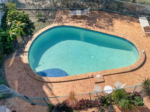 an overhead view of a large brick swimming pool at Cotton Tree Waterfront with Jetty in Maroochydore