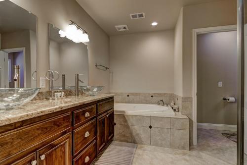 a bathroom with two sinks and a bath tub at Tahoe Woods Hideout in South Lake Tahoe