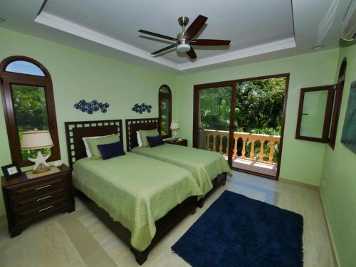a bedroom with a bed and a ceiling fan at Casa Lynda - 3 Bedrooms in West Bay