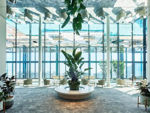 a large room with plants and a large window at Mitsui Garden Hotel Yokohama Minatomirai Premier in Yokohama