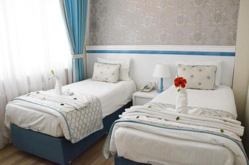 Ένα ή περισσότερα κρεβάτια σε δωμάτιο στο Star Holiday Hotel