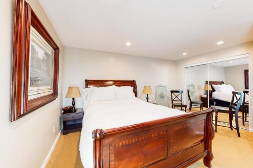 a bedroom with a large bed and a mirror at Crown Mountain Retreat in Carbondale
