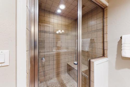 a shower with a glass door in a bathroom at Crown Mountain Retreat in Carbondale