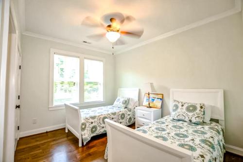 a bedroom with two beds and a ceiling fan at Coastal Treehouse in Wilmington