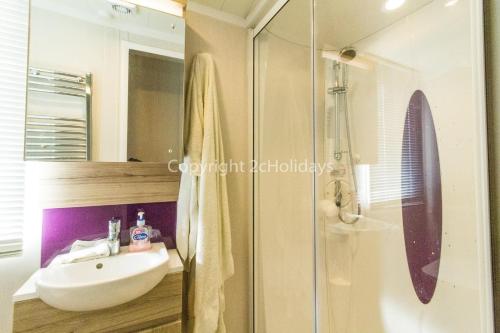 a bathroom with a sink and a shower at Superb 8 Berth Dog Friendly Caravan At Haven Caister In Norfolk Ref 30009d in Great Yarmouth