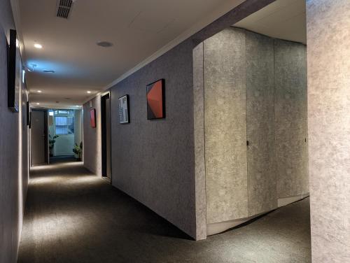 a hallway of a building with concrete walls at Meworld Hotel - Songshan in Taipei