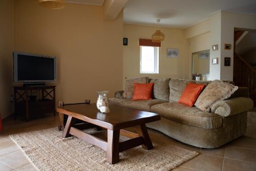 a living room with a couch and a coffee table at Villa Pasithea in Korfos