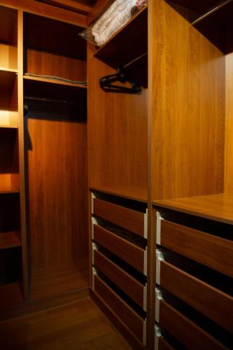 a walk in closet with wooden cabinets and drawers at Villa Pasithea in Korfos