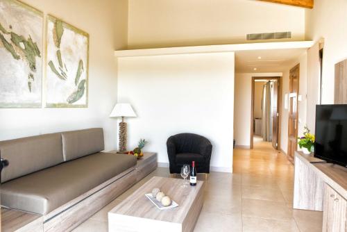 a living room with a couch and a tv at Hotel Son Trobat Wellness & Spa in Sant Llorenç des Cardassar