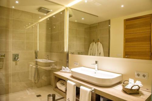 a bathroom with a sink and a shower and a mirror at Hotel Son Trobat Wellness & Spa in Sant Llorenç des Cardassar